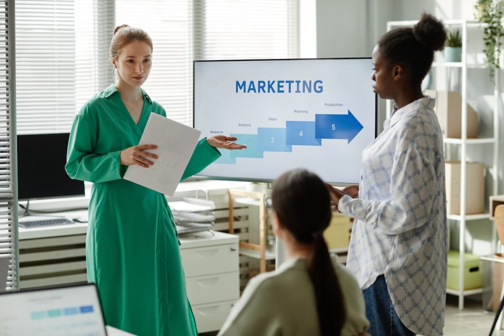 Woman-Giving-Business-Presentation-For-Colleagues